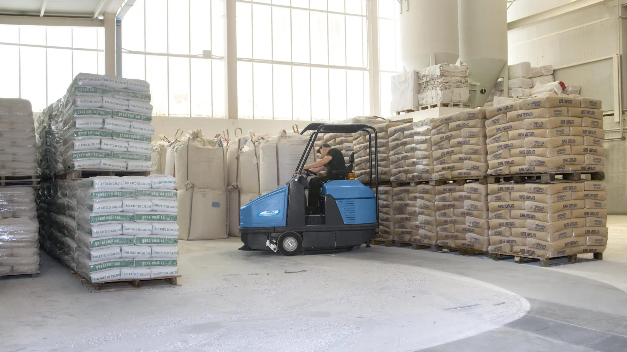 Ride-on sweeper cleaning a Brisbane warehouse floor
