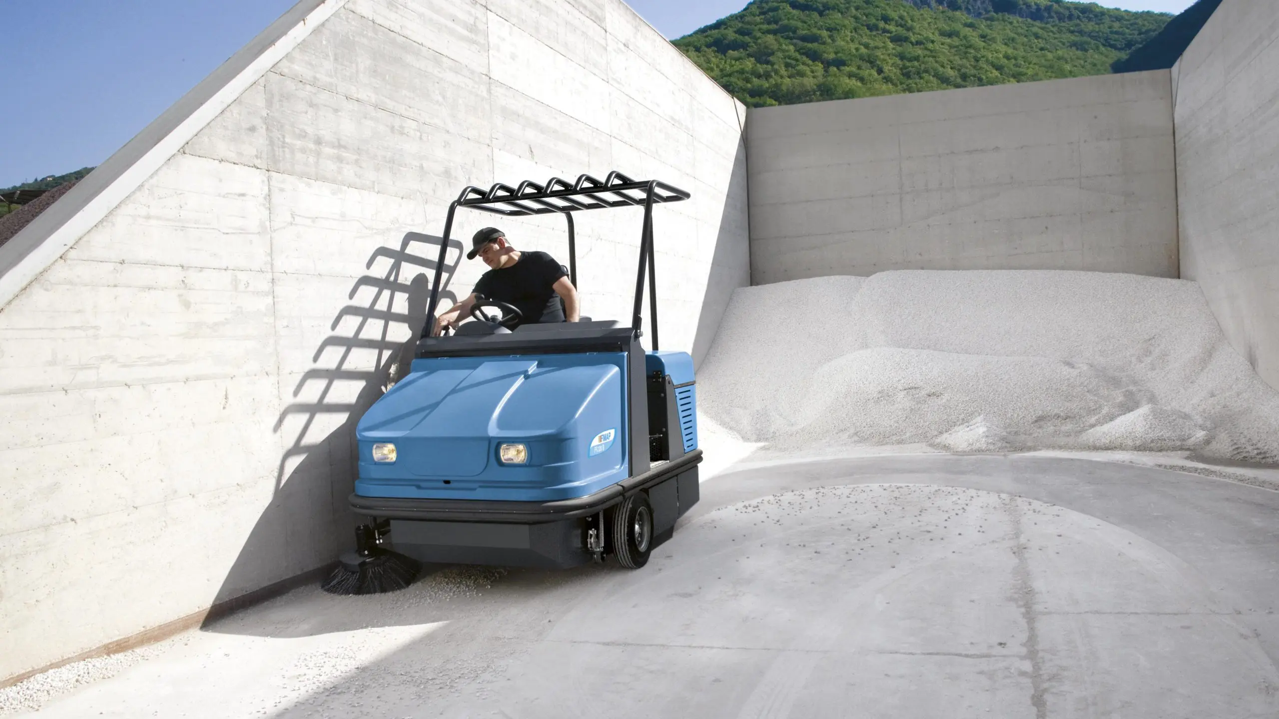 Industrial sweeper machine working on a hardstand area