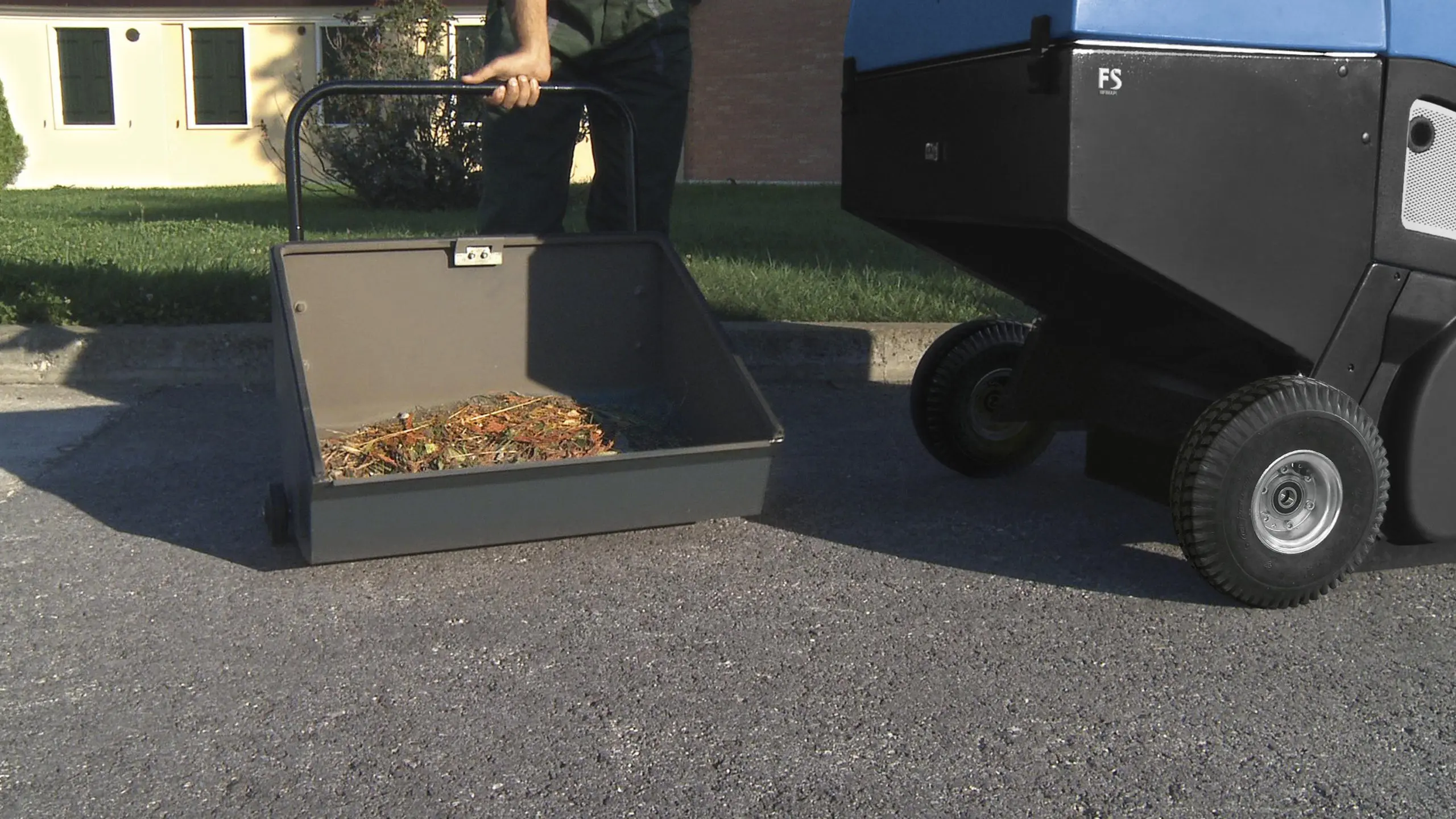 Sweeper hopper being emptied on site