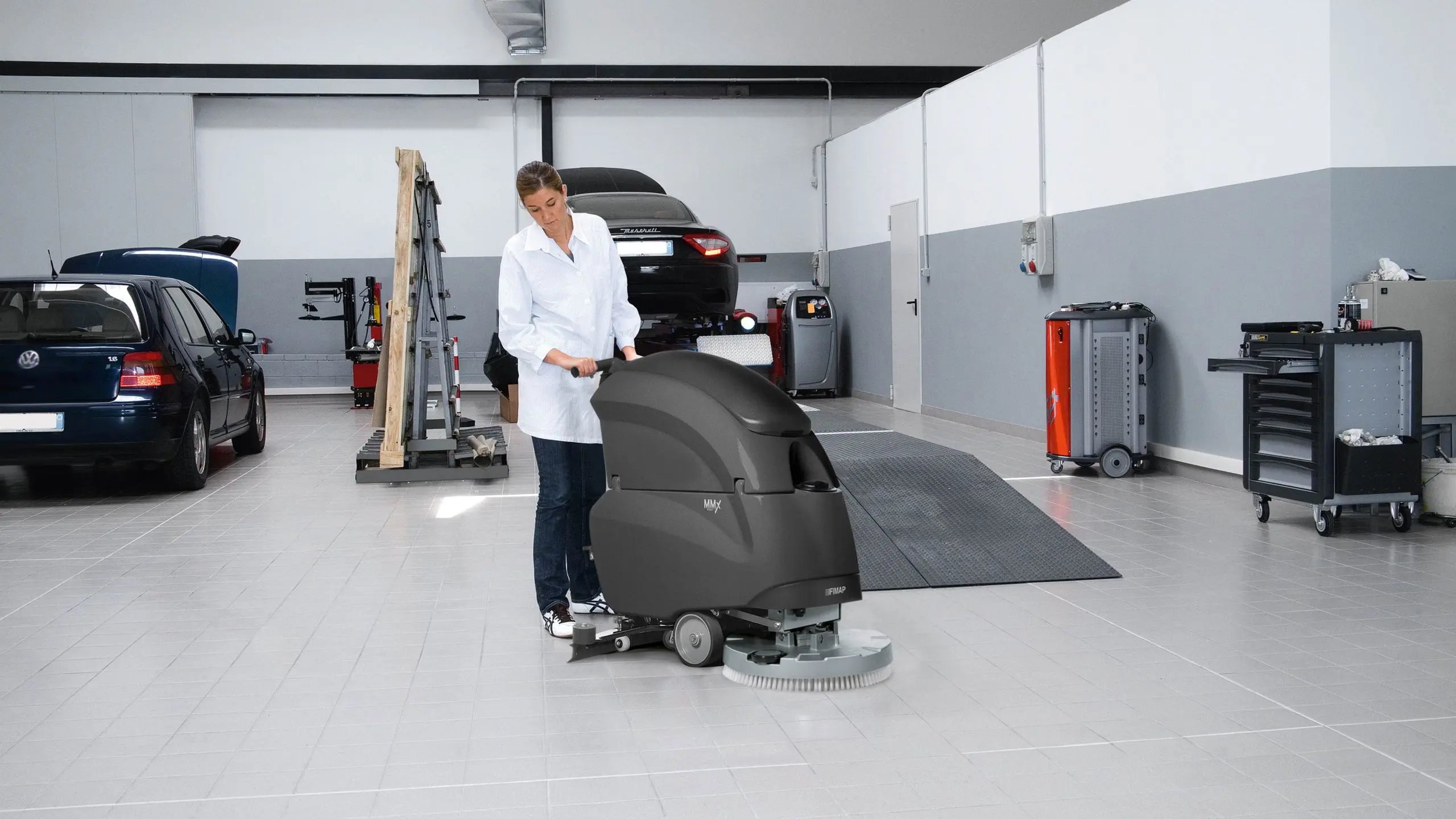 Walk-behind floor scrubber working in a tight service area