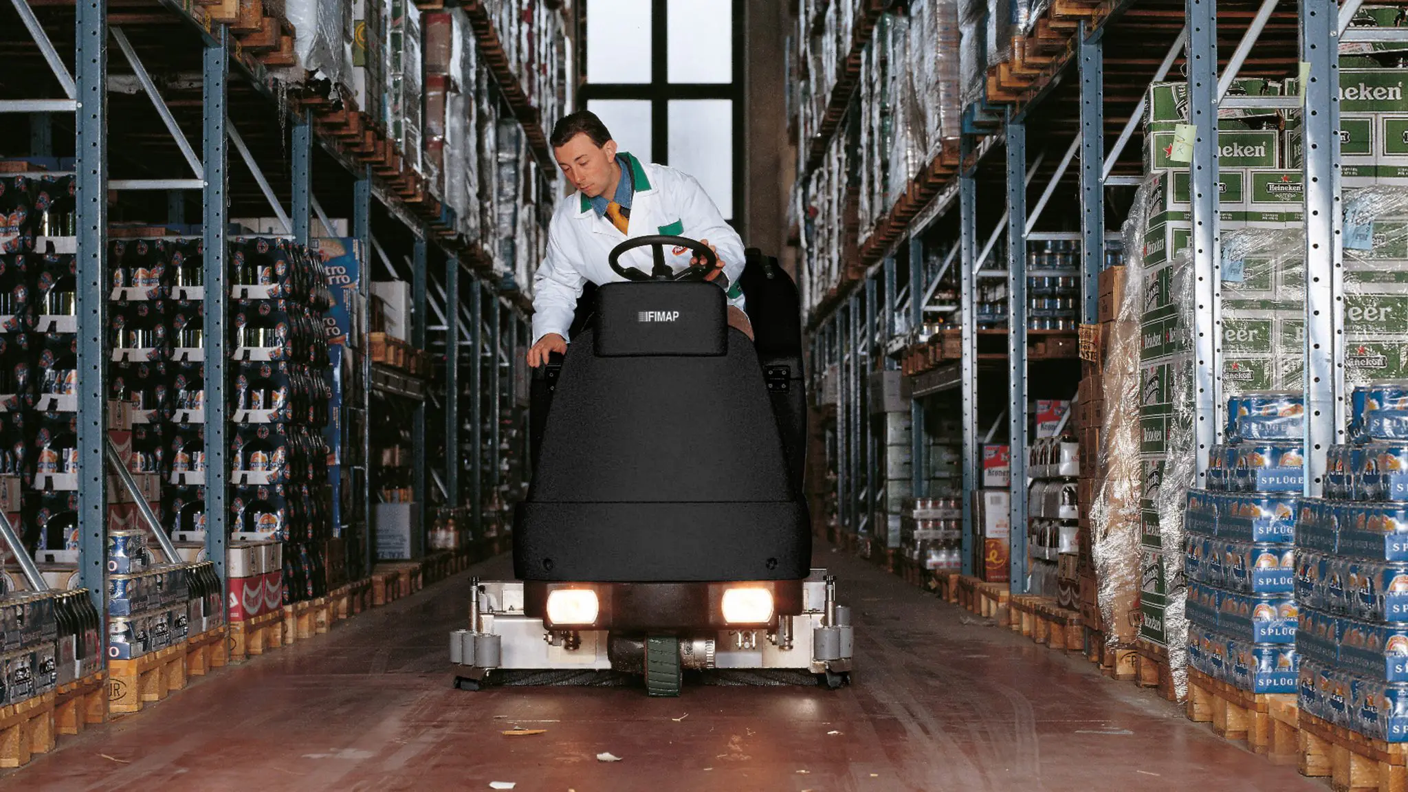 Ride-on sweeper cleaning a Logan distribution centre floor